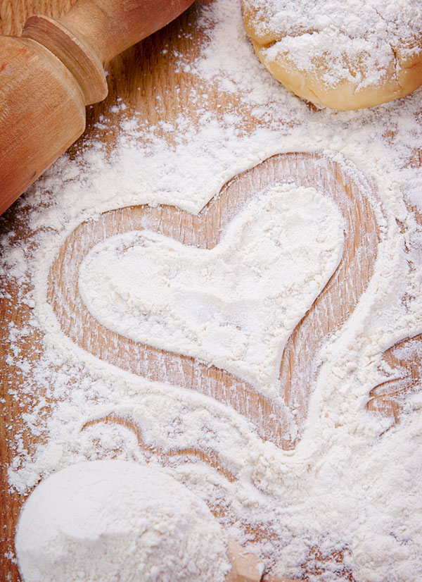 Heart drawn with flour on the kitchen table. Food ingredient