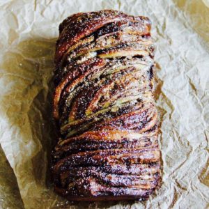 A loaf of bread with some type of meat on it