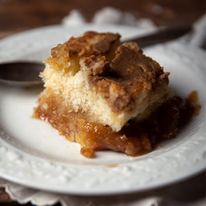 A piece of cake on top of a white plate.