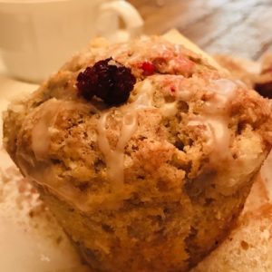 A muffin with some berries on top of it