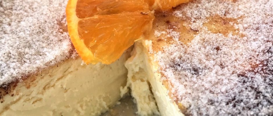 A close up of an orange slice on top of cake