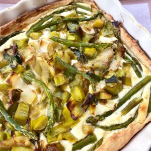A square pizza with green beans and potatoes.