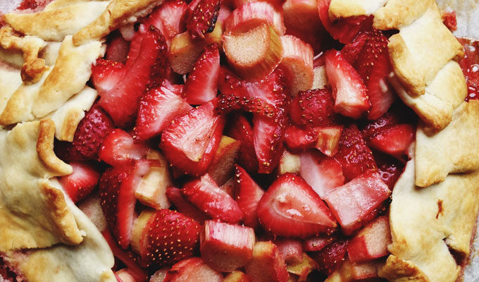 A pie with strawberries on top of it.