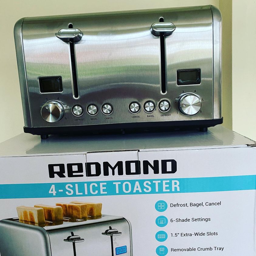 A toaster sitting on top of its box.