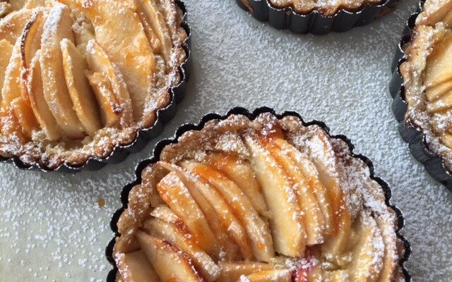 A close up of some apple tarts on a table