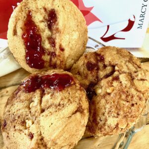 A close up of some cookies with jam on them